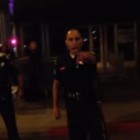 Grainy cellphone footage shows a man getting roughed up by police as officers attempt to control the scene.