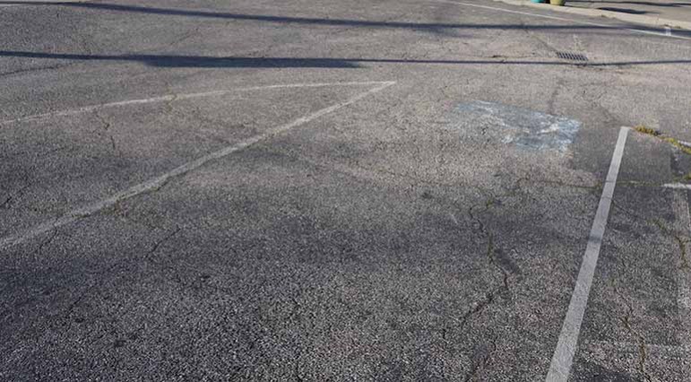 Paint marking designated handicap parking spots outside Cute Flowers and Gifts in Santa Clara has faded—a violation of ADA rules.