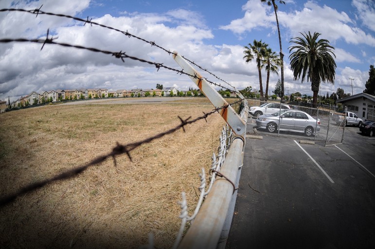 The site slated for redevelopment has been vacant for a dozen years. (Photo by Greg Ramar)