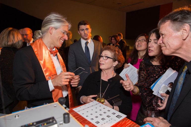 Martin Aufmuth, left, invented a box that can create as many as 50,000 pairs of reading glasses that cost roughly a dollar per frame. (Photo by Jakob Mosur, courtesy of Tech Museum)