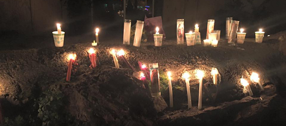 People lit candles by GP Sports, where Kyle Myrick worked and the last place he was seen alive. (Image via Facebook)