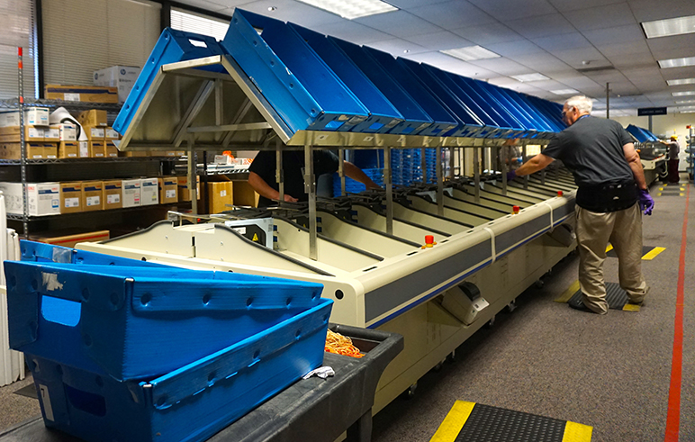 Santa Clara County election workers sort mail-in ballots. (Photo by Jennifer Wadsworth)