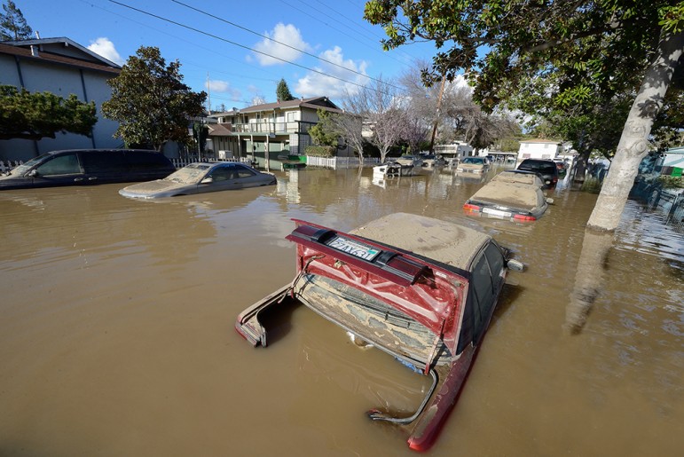 Many vehicles were ravaged by flood water as residents received little or no warning. (Photo by Greg Ramar)