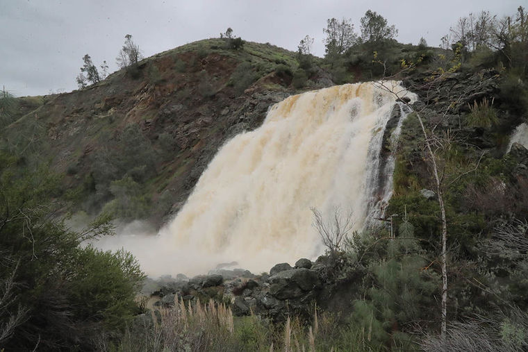 Anderson Reservoir reached the emergency spillway for the first time since 2006, creating a waterfall into Coyote Creek. This photo was taken Feb. 19. (Photo by Robert Eliason, via Morgan Hill Times)