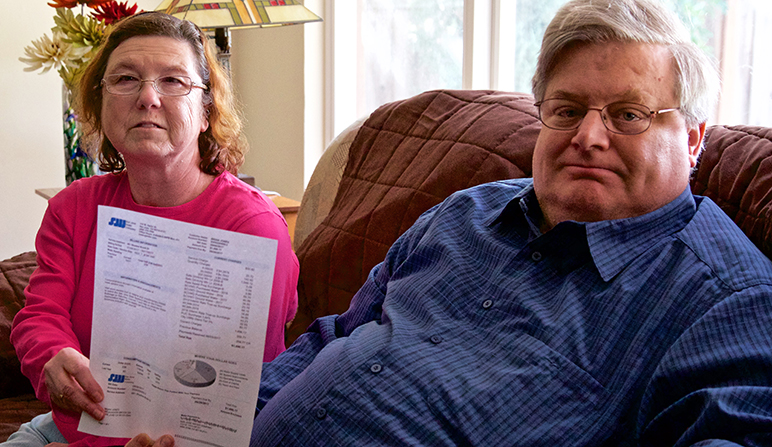 Brian and Aimee Jones with their $1,696 water bill from September 2017 in their San Jose home. (Photo by Kevin N. Hume)