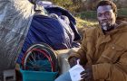 Sharwian Bobian sits outside his makeshift shelter.